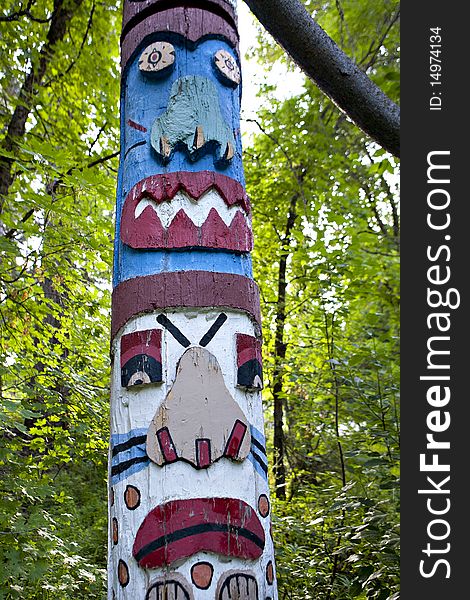 A colorful totem pole in the forest.