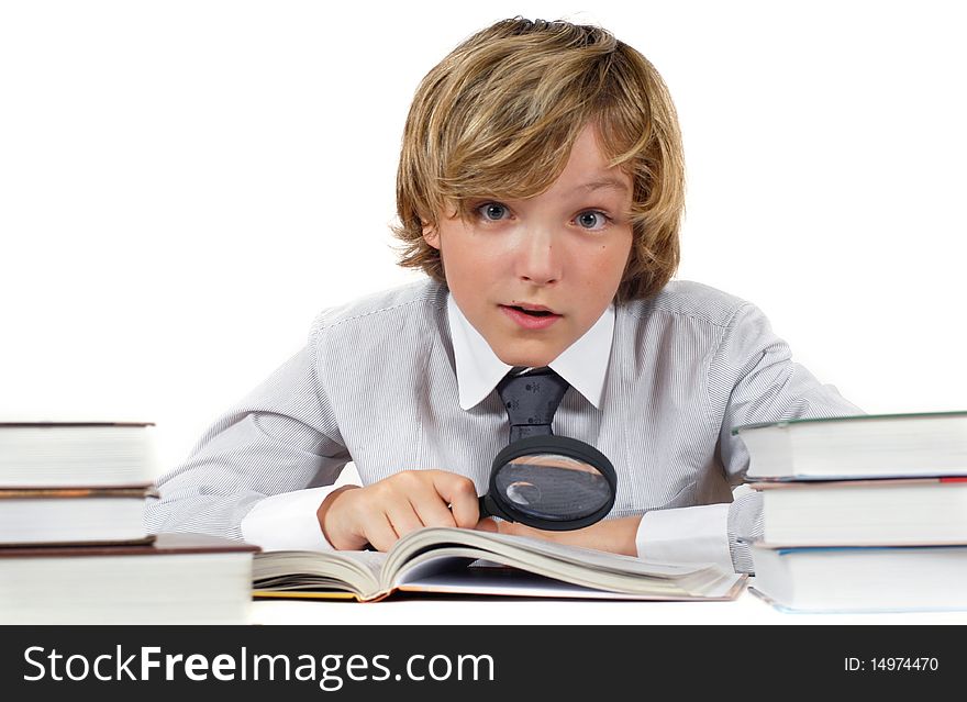 Schoolboy with books and magnifying glass isolated on white