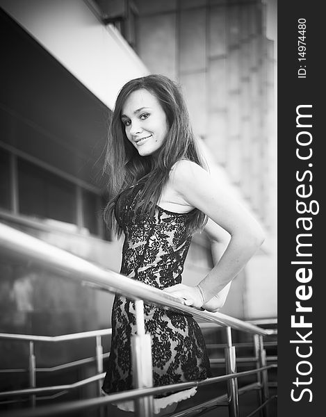 Black and white photo: girl near stair railing