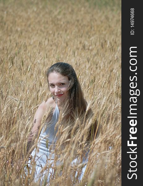 Beautiful young woman having fun on a wheat field. Beautiful young woman having fun on a wheat field