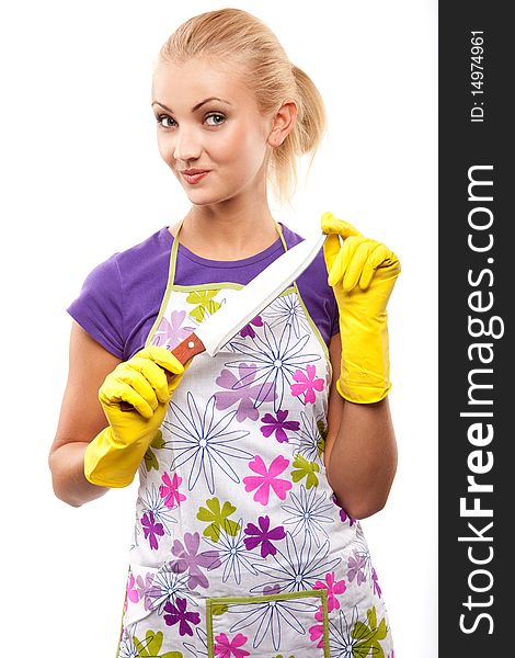 Young beautiful housewife in rubber yellow gloves with knife. Young beautiful housewife in rubber yellow gloves with knife