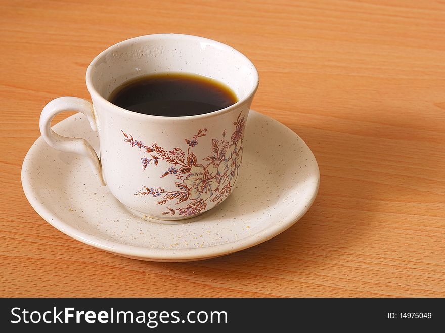 A mug of coffee with a wooden background