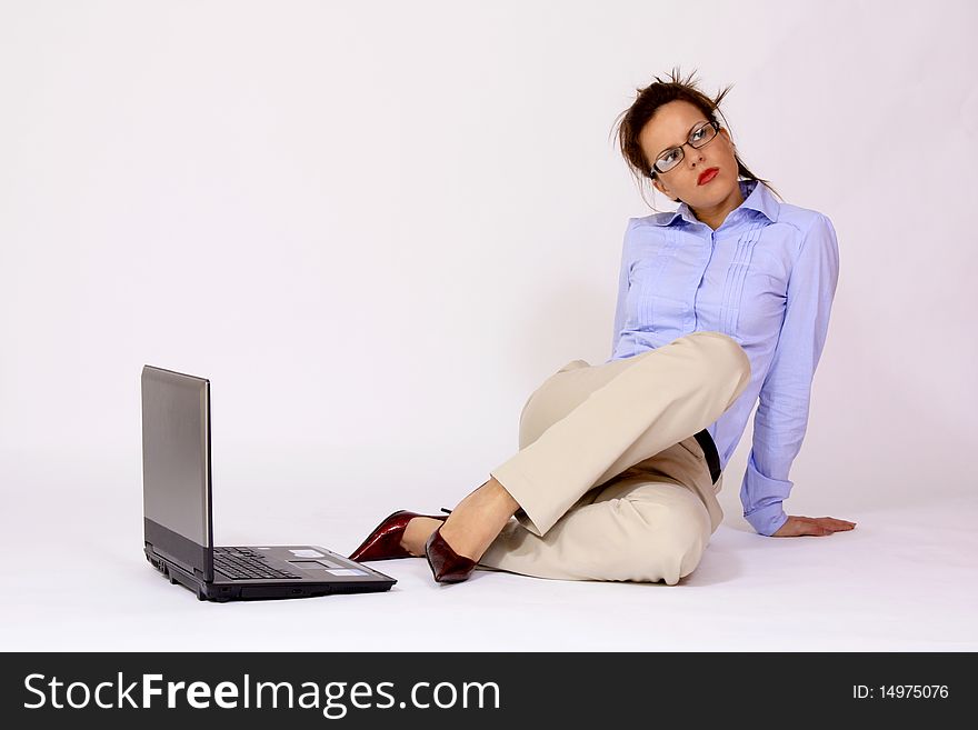 Girl with eyeglasses sitting by the lap top communication expression
