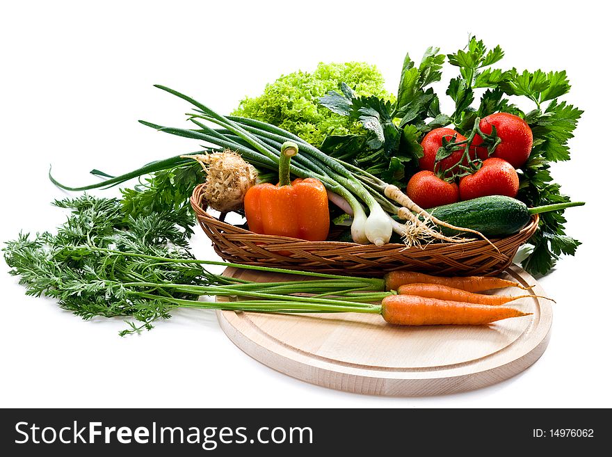 Organic vegetables in basket on white background