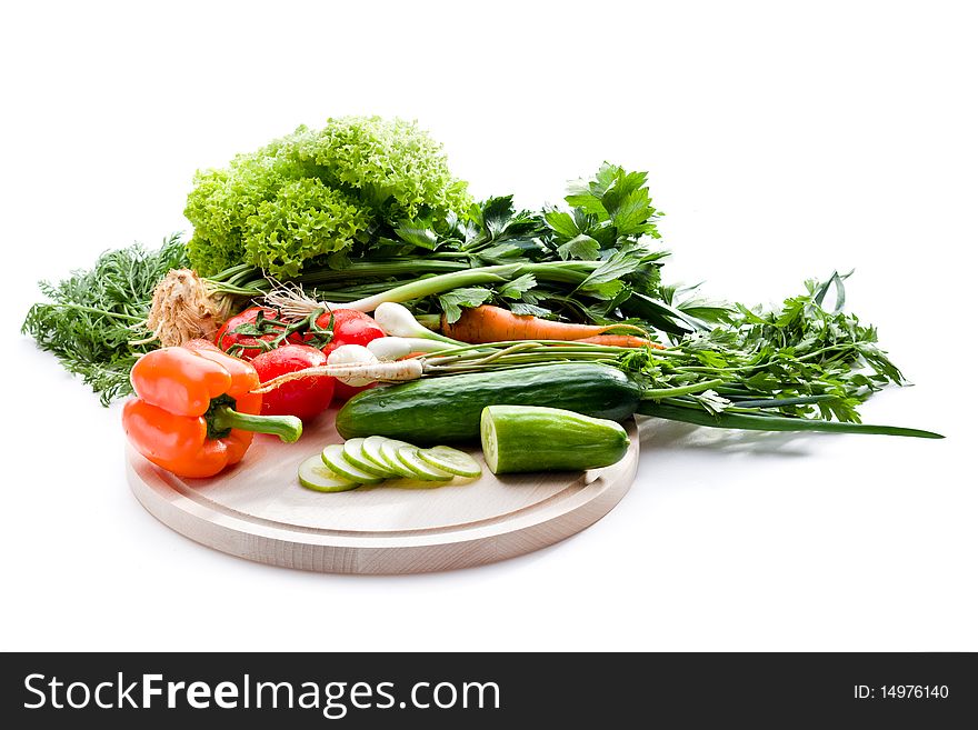 Raw vegetables on cutting board on white background