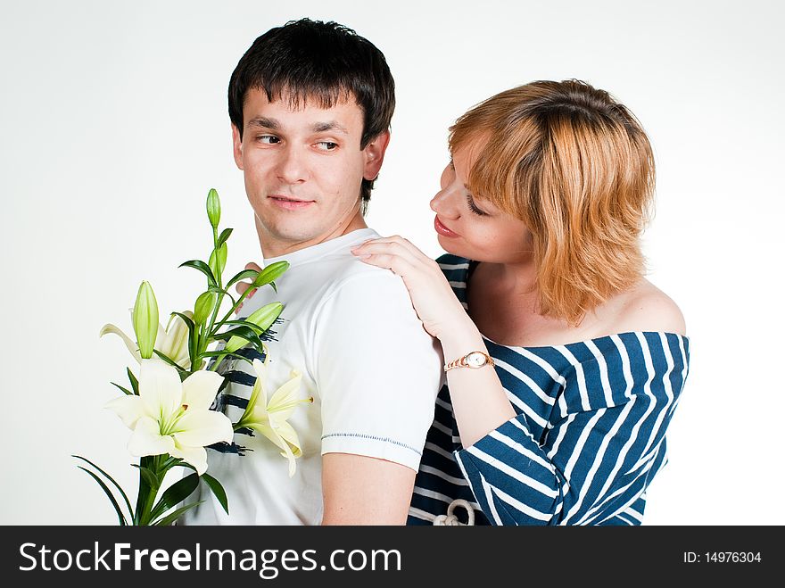 Beautiful young couple with white lilies