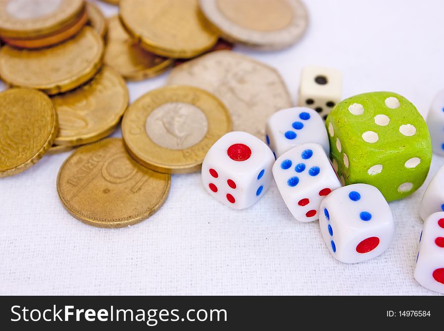 Coins and different dice on white. Coins and different dice on white