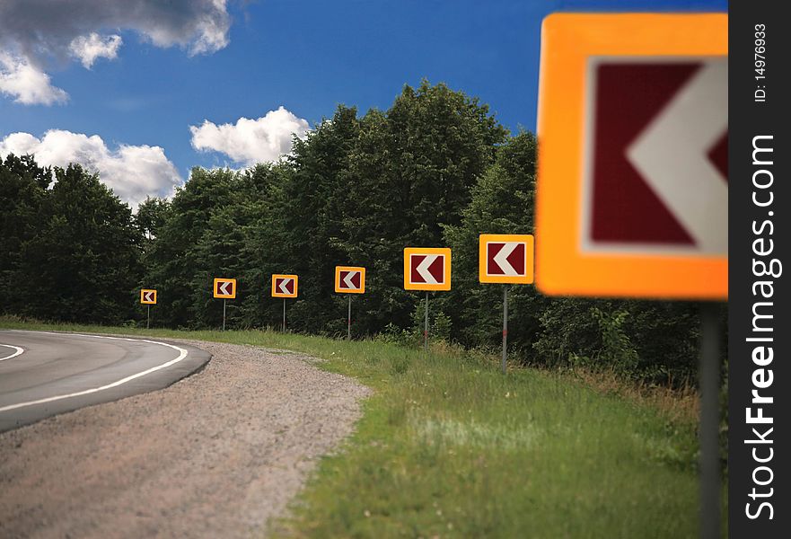 Signs attention to road turn in wood. Signs attention to road turn in wood