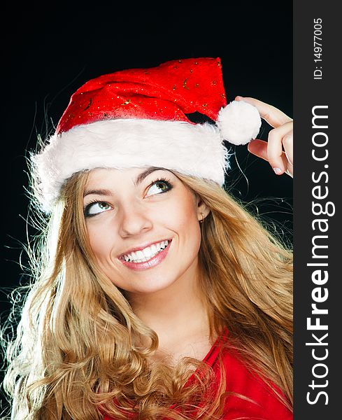 Young pretty girl with long hair in Santa hat. Young pretty girl with long hair in Santa hat