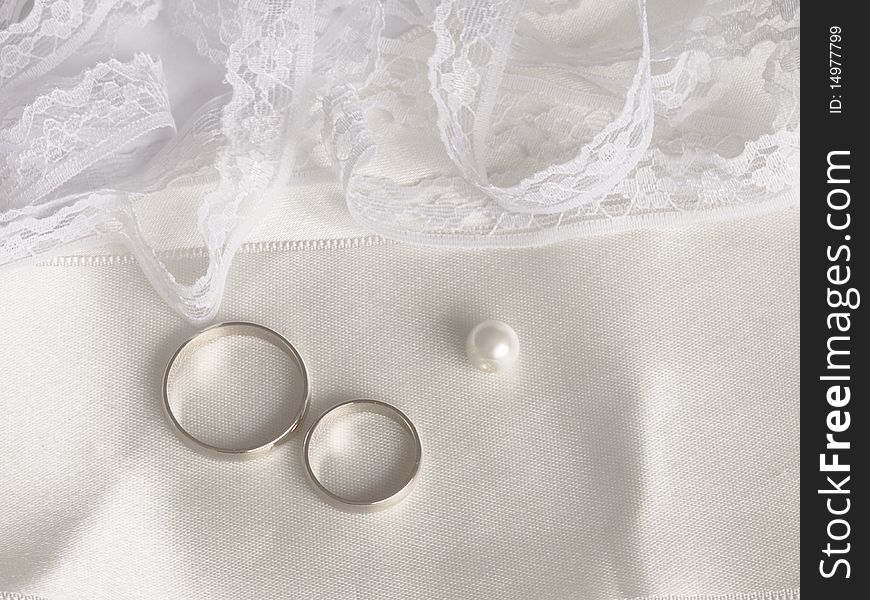 With golden rings, pearl and lace. With golden rings, pearl and lace