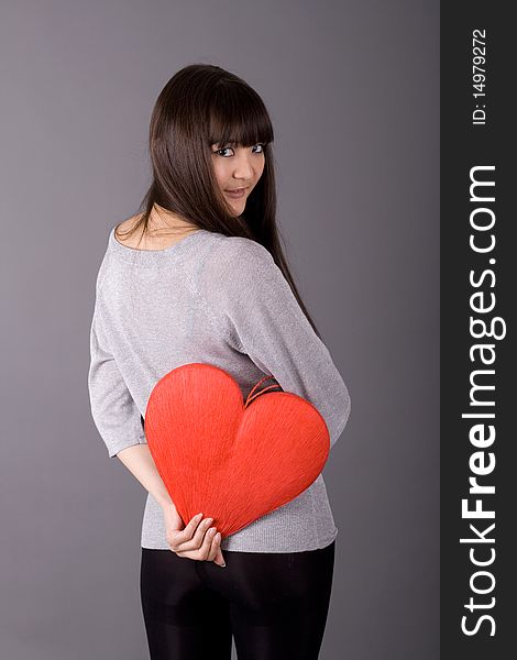 Beautiful woman holding red heart