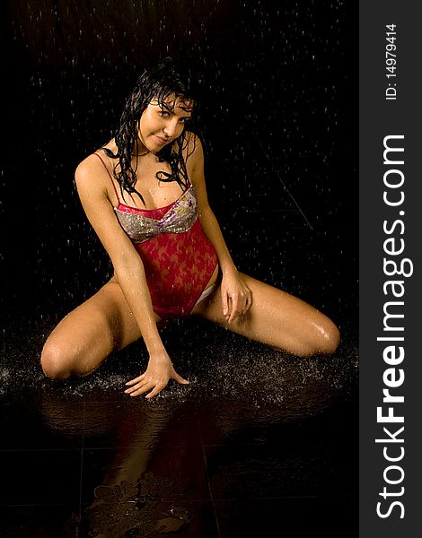 Full length portrait of a sexy woman in water studio