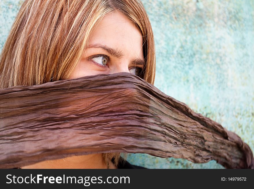 Blonde girl with her mouth hidden by scarf. Blonde girl with her mouth hidden by scarf