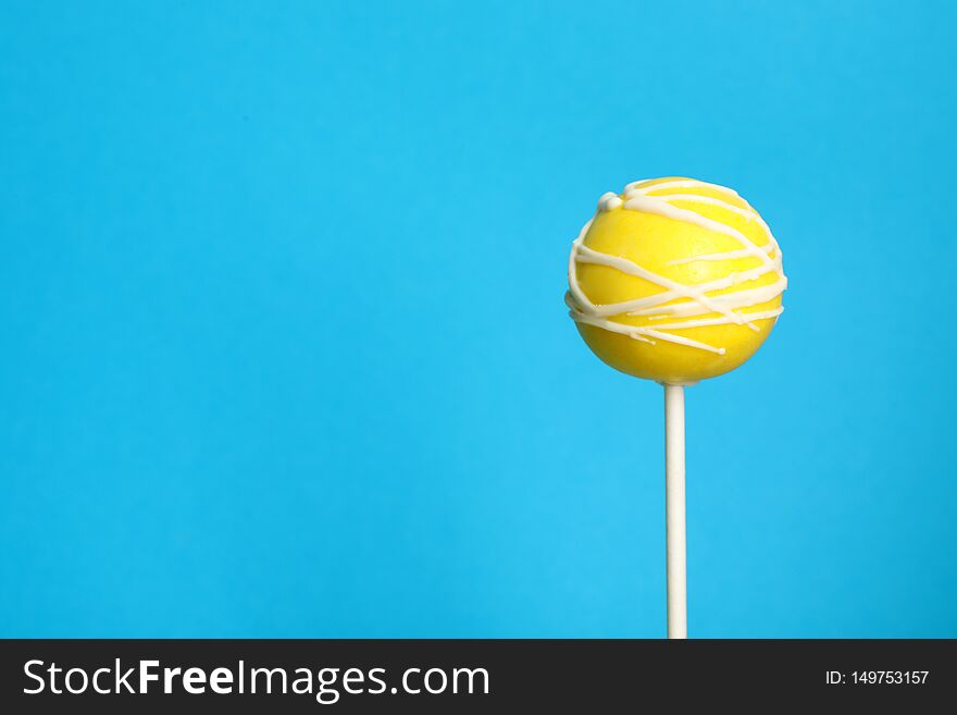 Bright delicious cake pop on color background