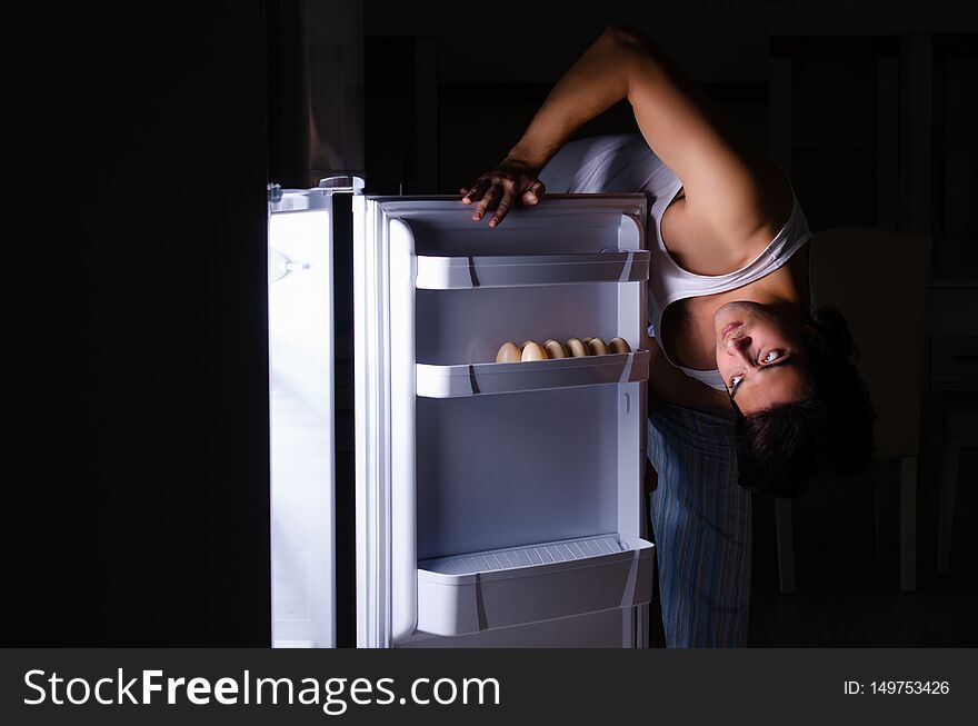 Man Breaking Diet At Night Near Fridge