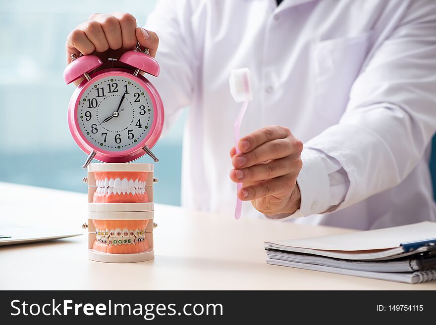 The male doctor stomatologist working in the clinic