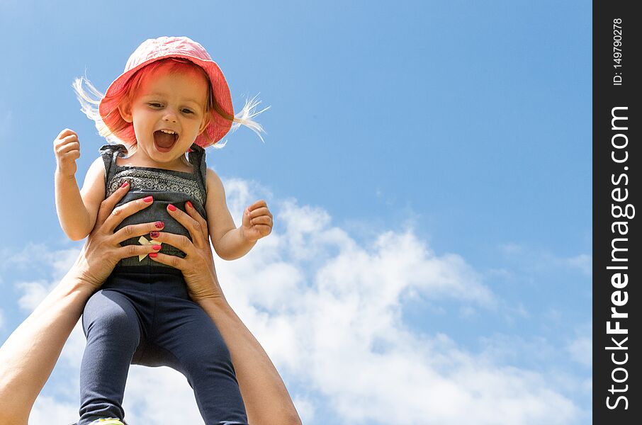 Parent Throws Up a Happy Baby in the Sky. Summer Concept. Parent Throws Up a Happy Baby in the Sky. Summer Concept