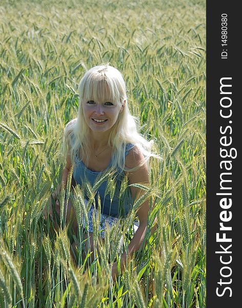 Blond woman in field of wheat