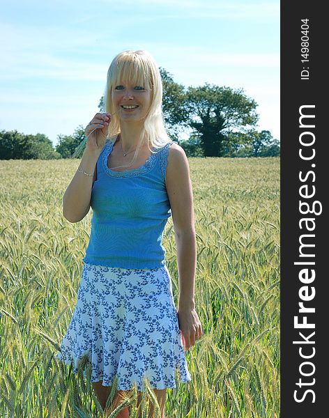 Blond woman in field of wheat