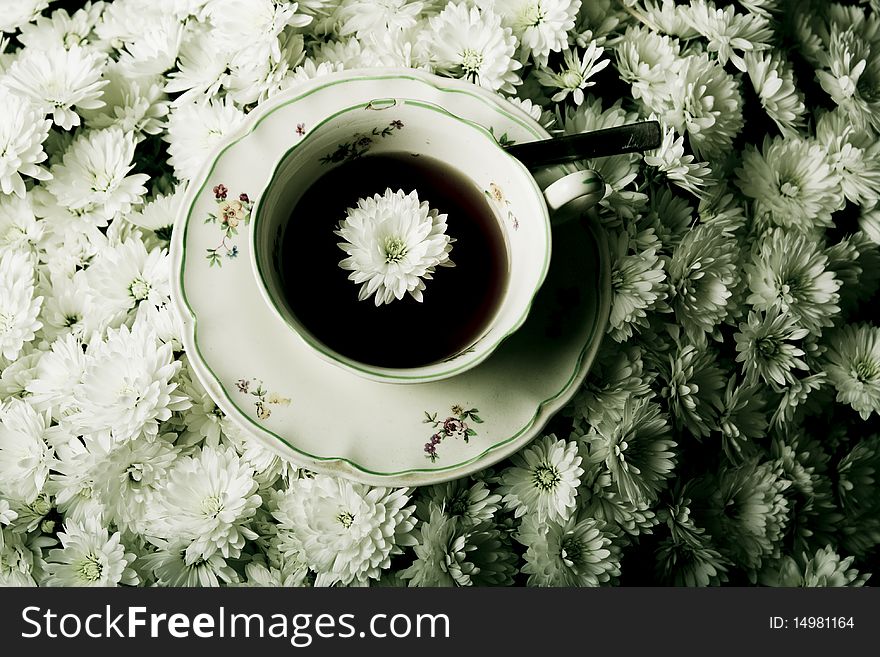 Cup of tea in flowers surrounding