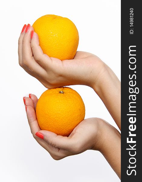 Two hands holding oranges stacked on top of each other. On solid white background. Two hands holding oranges stacked on top of each other. On solid white background.