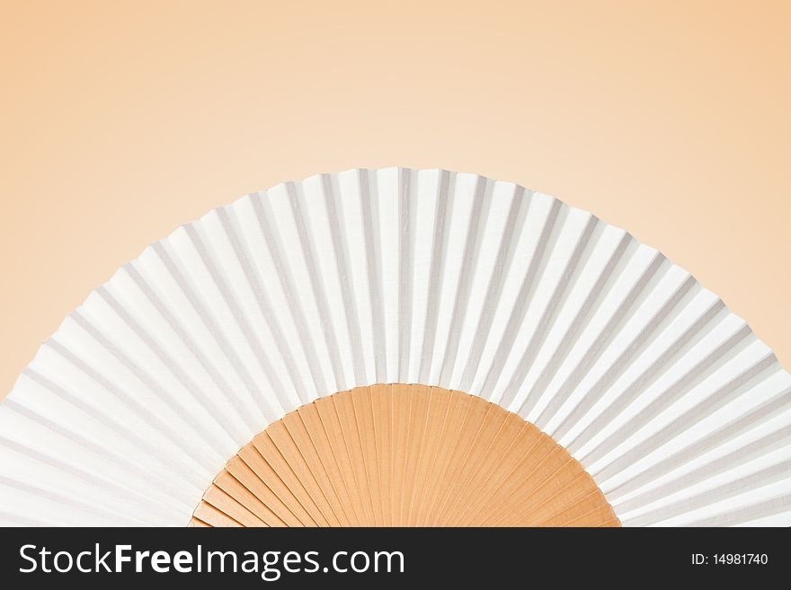 Folding fan isolated on a yellow background.