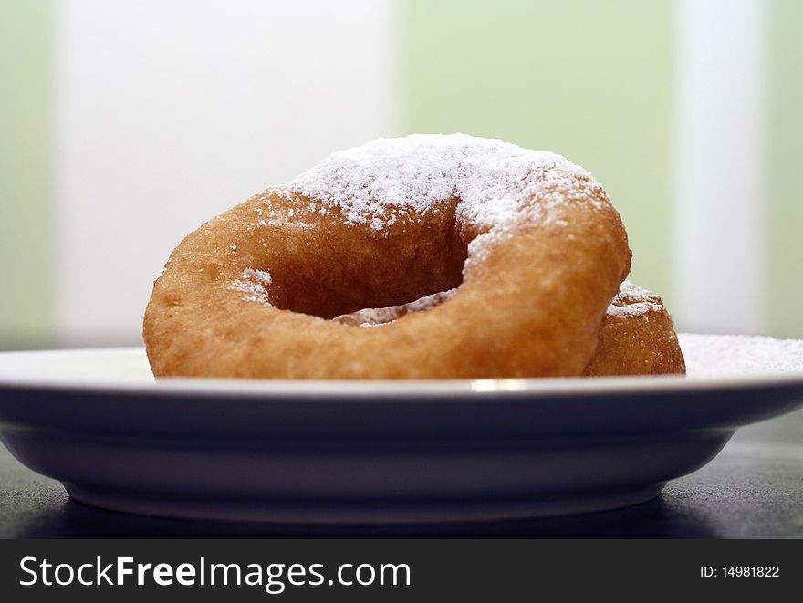 Two Russian   doughnuts on the plate with sugar