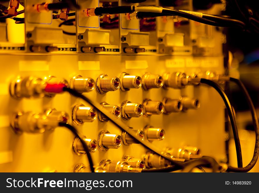 Orange Rack Mounted Servers with cables.;landscape shot