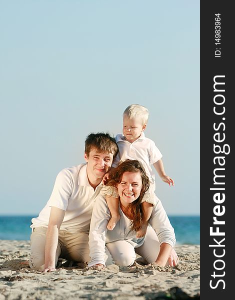 Young happy family on beach