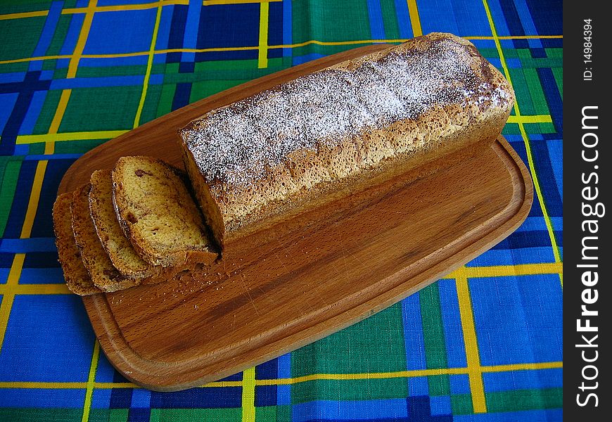 Sliced sponge cake on a wooden board. Sliced sponge cake on a wooden board