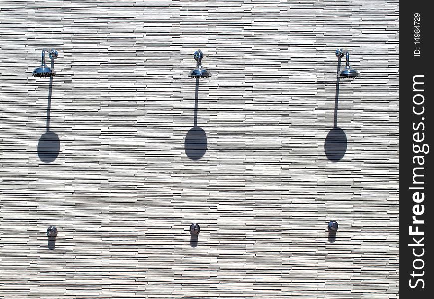 Three Shiny showerhead on the wall of resort hotel at the outside. Three Shiny showerhead on the wall of resort hotel at the outside