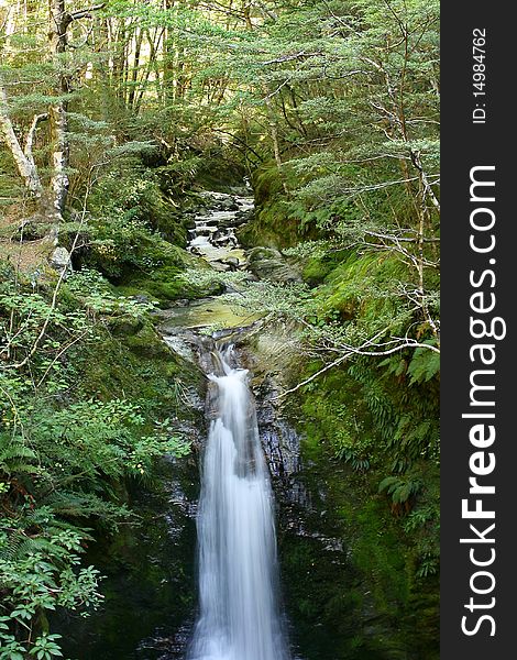 A small stream running over a waterfall, Otago, New Zealand. A small stream running over a waterfall, Otago, New Zealand