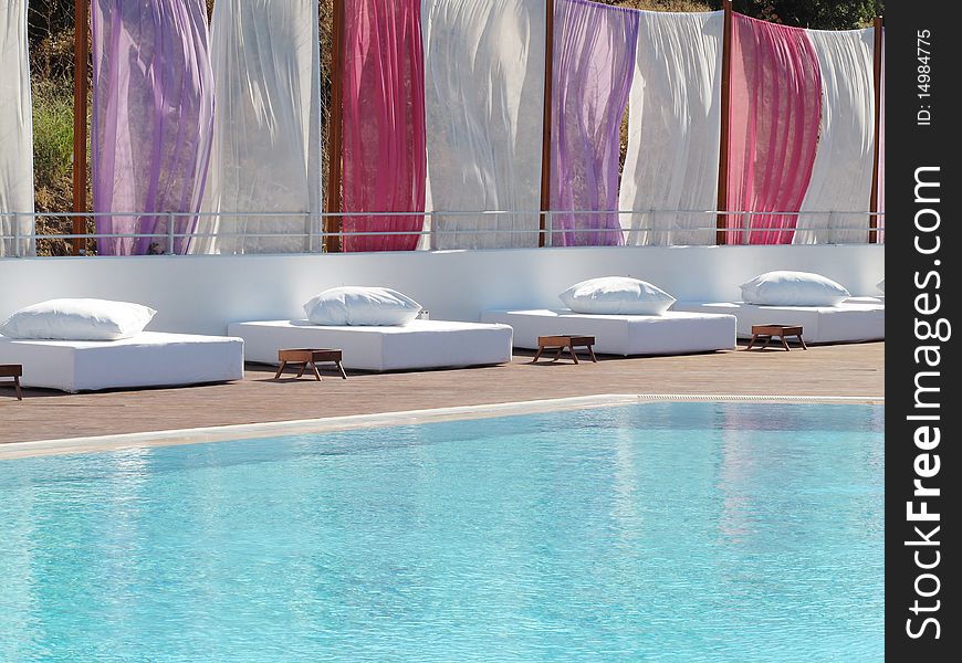 Lounge beds at the swimming pool of luxury resort hotel