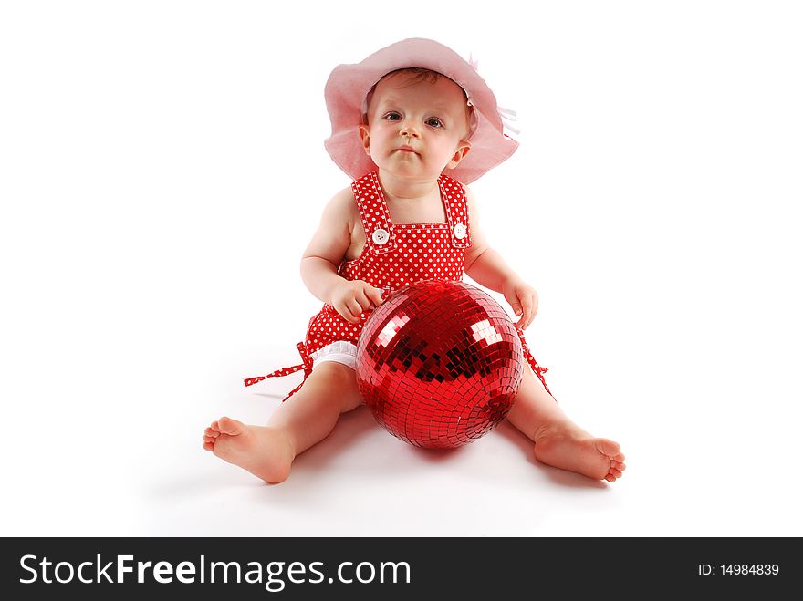 Little baby girl in red dress and hat with red ball