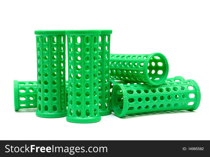 Green curlers isolated on a white background. Series: professional hairdressing tools. Green curlers isolated on a white background. Series: professional hairdressing tools