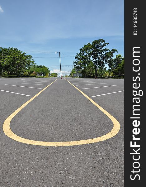 Empty parking lane with blue sky