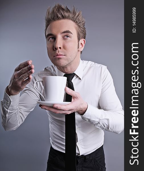 Young attractive macho drinking coffe. photo