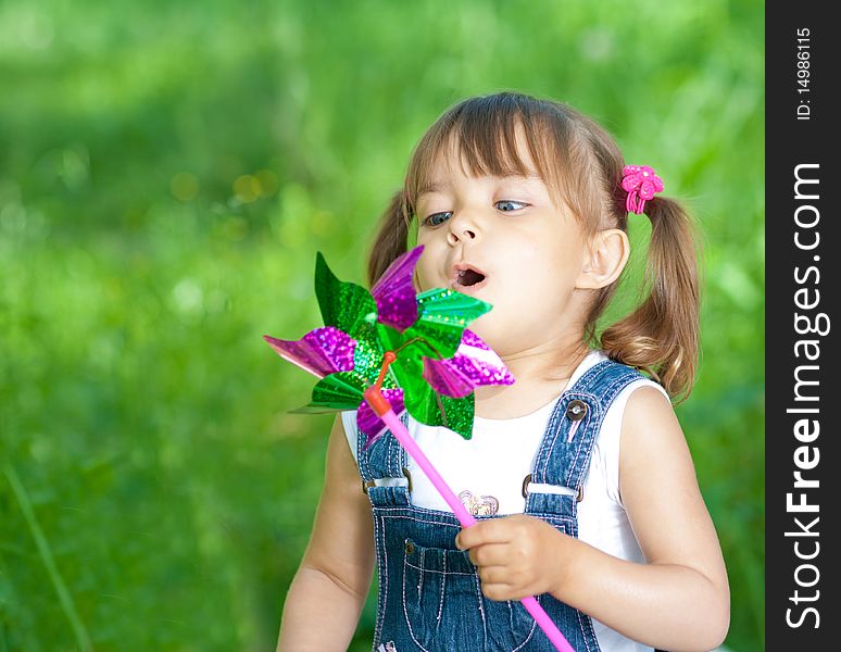 Little Girl Blowing On Propeller Summertime