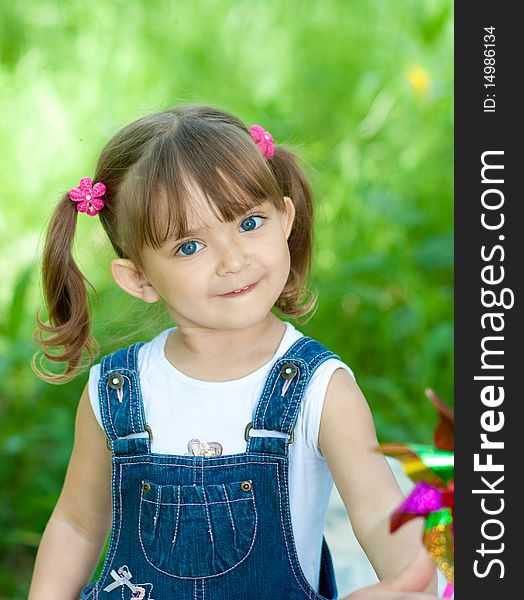 Smiling little girl in jeans with blue eyes outdoor. Smiling little girl in jeans with blue eyes outdoor