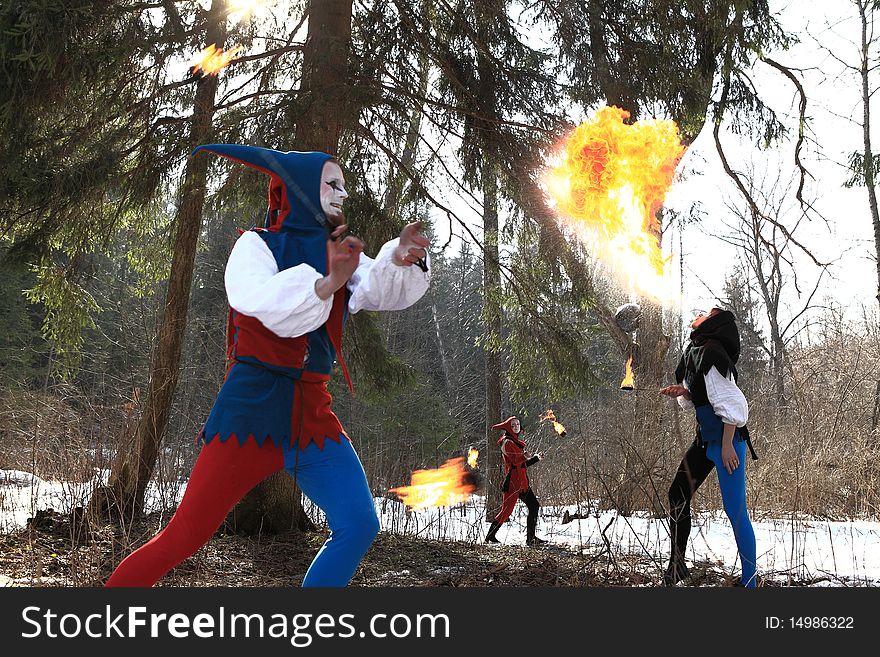 Group of retro fire-eater showing fire-show