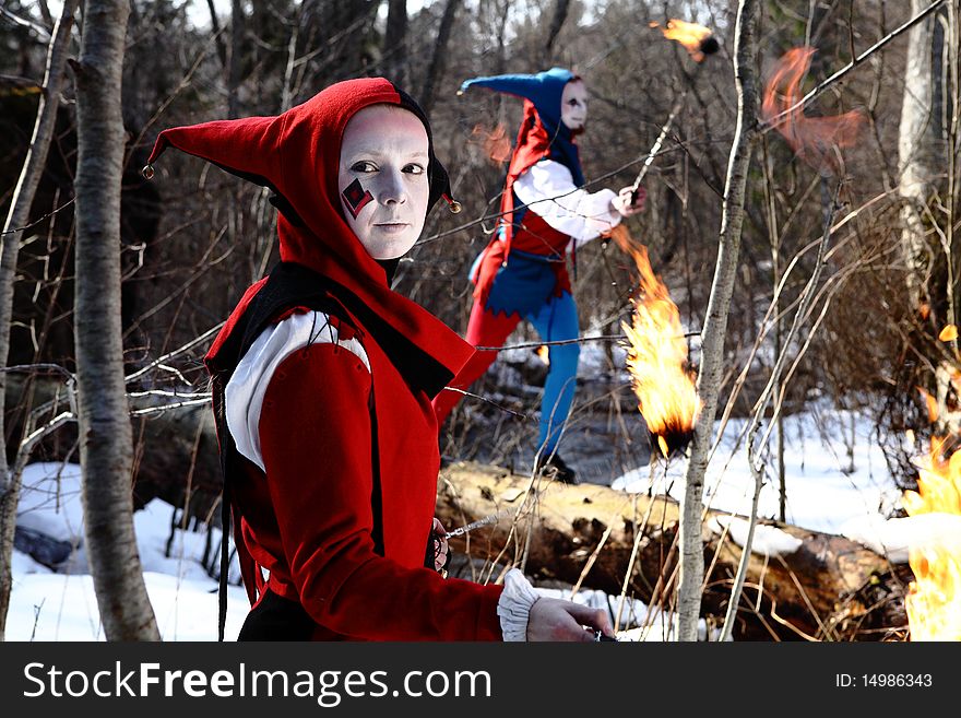 Ancient Art collective showing elements of fiery show on a forest. Photo.