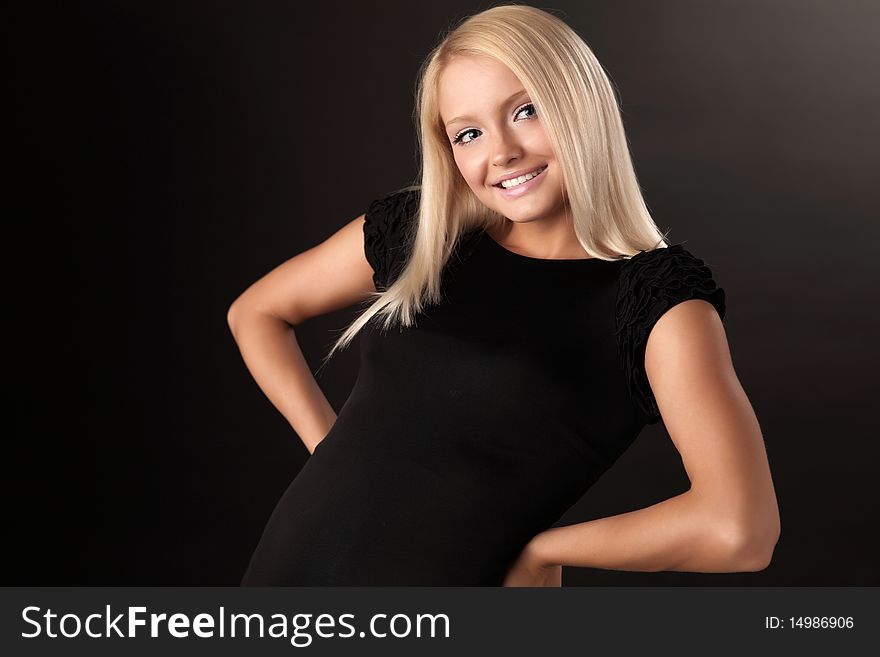 Attractive Blond Beauty Posing In Dark Background