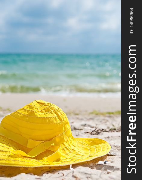One yellow hat in the beach near sea