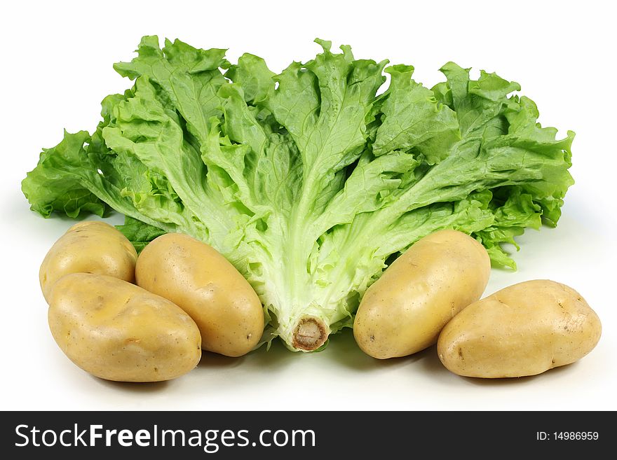 Potatoes and  lettuce on white background. Potatoes and  lettuce on white background