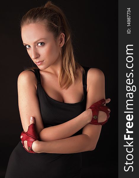 Attractive posing blonde in a red sport gloves. Fashion photo.
