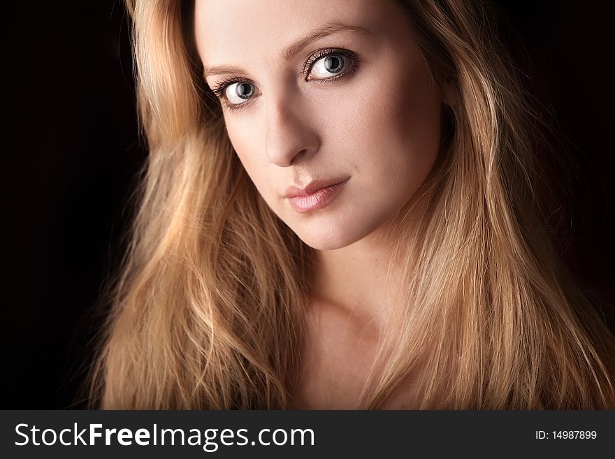 Portrait of attractive young blond woman. Photo.