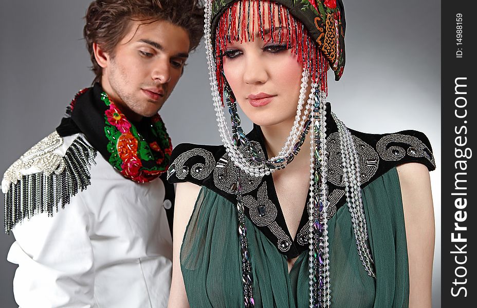 Pair models in exclusive design clothes on manners old-slavic. Photo.