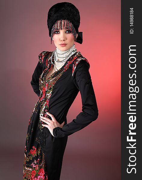 Attractive model in exclusive design clothes on manners old-slavic. Photo.