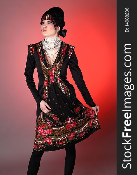 Attractive model in exclusive design clothes on manners old-slavic. Photo.