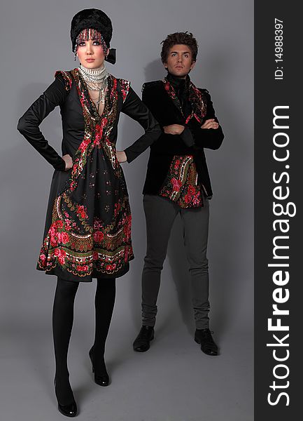 Pair models in exclusive design clothes on manners old-slavic. Photo.